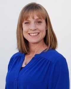 Picture of Anna Ceder white woman with blond hair smiling and wearing a blue shirt