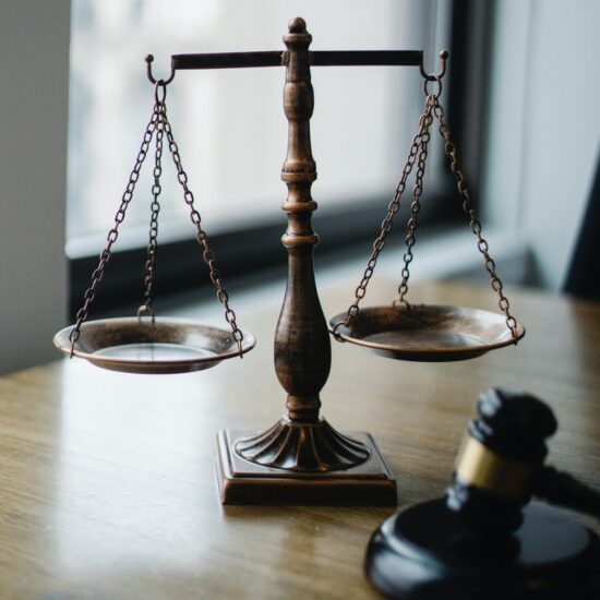 scales and gavel on a desk. credit to Sora Shimazaki