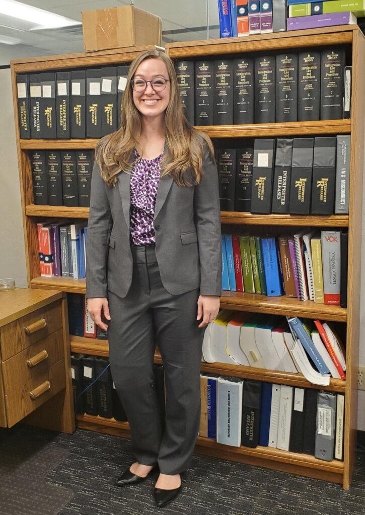 Paige Ricks in front of bookshelf full of books